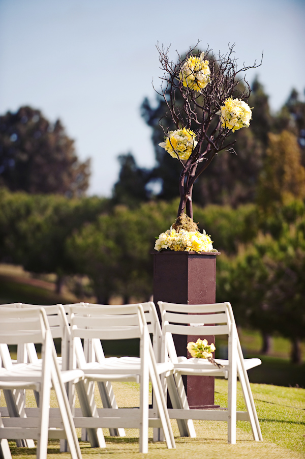Ceremony floral detail - Yellow floral arrangement in altar area - photo by San Francisco based wedding photographer Meg Perotti